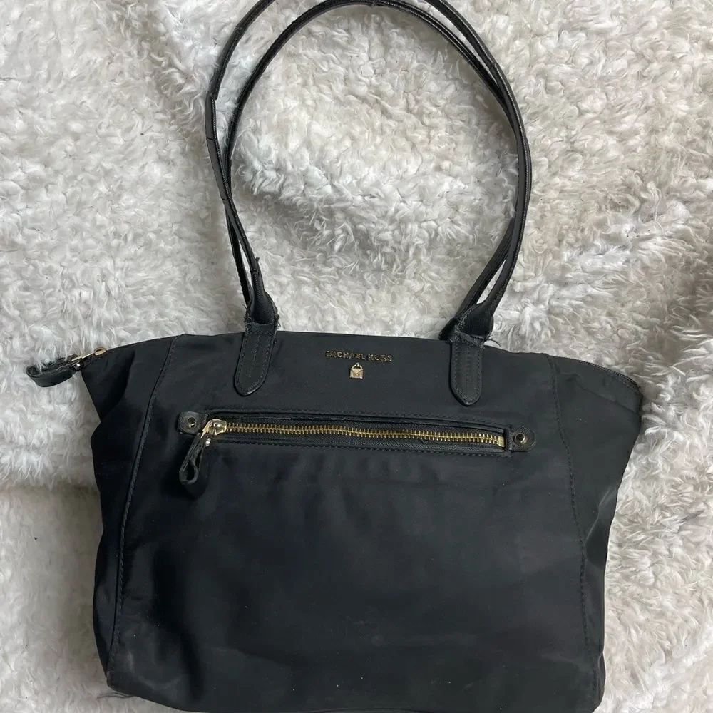 Michael Black Nylon Medium shoulder bag with gold tone hardwares.
